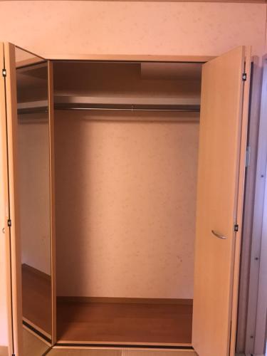 a closet with a door open in a room at Minpaku Momotaro Bekkan in Kasugai