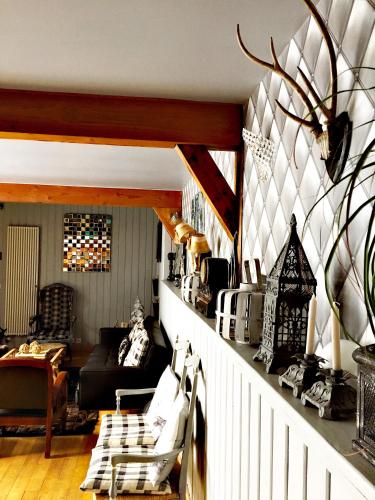 a living room with a couch and a table at Le Solayan in Couledoux