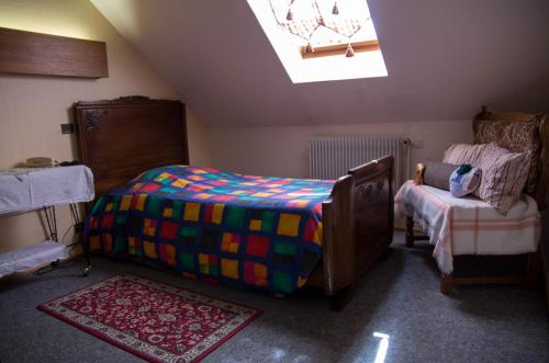 a small bedroom with a bed and a small table at Hôtel de Bâle in Bantzenheim