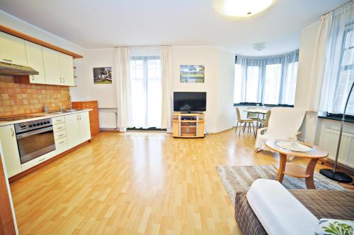 a kitchen and living room with a hard wood floor at Apartamenty Haffnera by Grand Apartments in Sopot