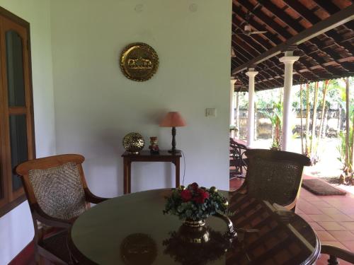 a dining room with a table and chairs at Kovilakam Lakeside Villa in Alleppey