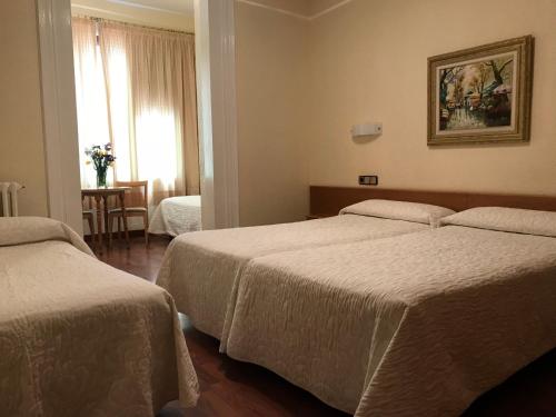 Postel nebo postele na pokoji v ubytování Hotel Pelayo