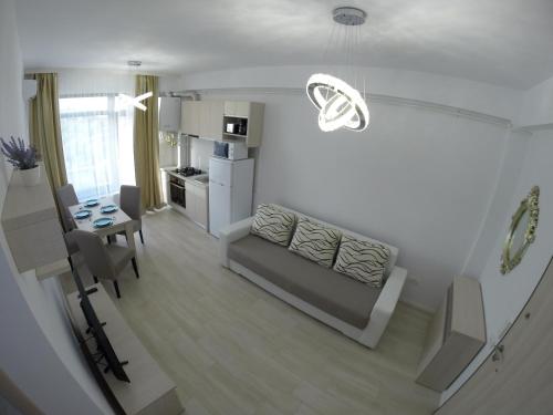 a living room with a couch and a table at Lotus nr 9 Mamaia Apartments Sea View in Mamaia