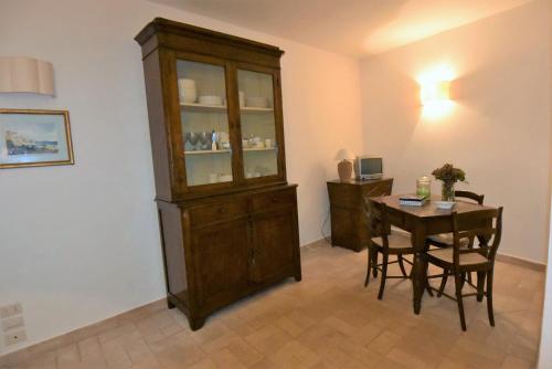 a dining room with a china cabinet and a table at La casetta a Torre di Palme in Fermo
