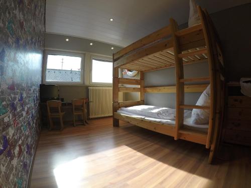 a bedroom with two bunk beds and a table at Holiday Home Kötz in Günzburg
