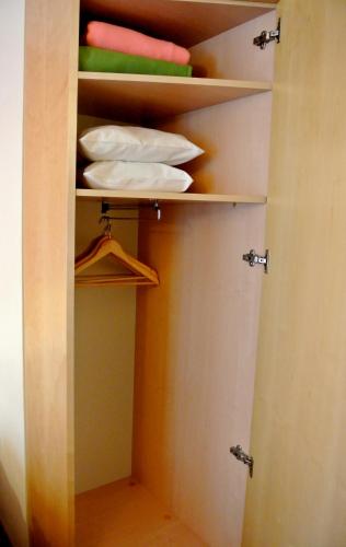 a closet with some towels and a hanger at Town Hotel Wiesbaden - kleines Privathotel in Bestlage in Wiesbaden