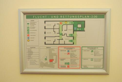 a sign hanging on a wall with a map at Town Hotel Wiesbaden - kleines Privathotel in Bestlage in Wiesbaden