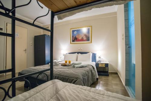 a bedroom with two beds in a room at Anita Hotel in Piraeus
