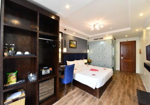 a bedroom with a bed and a desk in a room at Bella Rosa Trendy Hotel & Spa in Hanoi