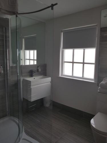 a bathroom with a sink and a shower at The Angel Inn in Warminster