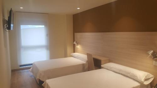 Postel nebo postele na pokoji v ubytování Hotel Hormilla