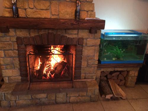 a brick fireplace with a fish tank in it at Hotel Grant in Kharkiv