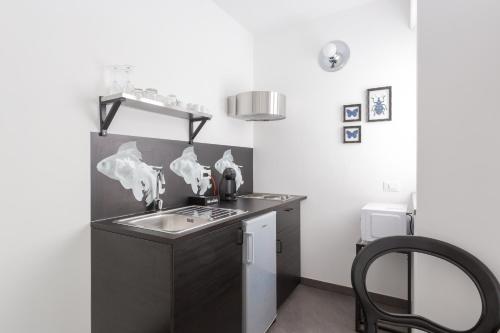 a kitchen with a sink and a counter top at Minerva Residence in Lavena Ponte Tresa