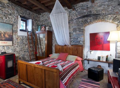 a bedroom with a bed and a stone wall at I Glicini in Lerici