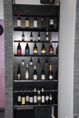 a shelf filled with lots of bottles of wine at B&B Rose in Vranje