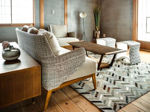 a living room with wicker chairs and a table at NIPPONIA Sawara Merchant Town Hotel in Katori