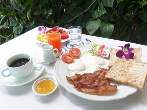 a plate of breakfast food with eggs bacon and toast at New Siam II in Bangkok