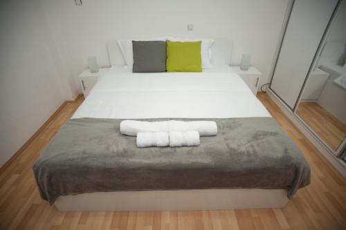 a bedroom with a bed with two towels on it at Vila Vanila in Gevgelija