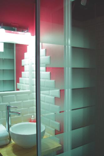 a bathroom with a sink and a glass shower at Hotel Cote Patio in Nîmes