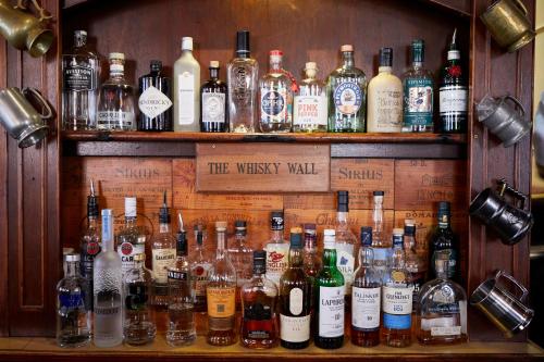 a display of bottles of alcohol on shelves at Wykeham Arms in Winchester
