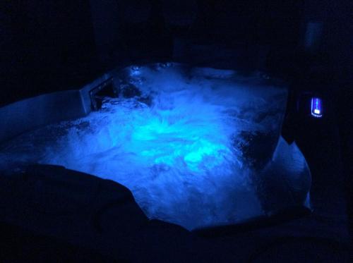 a dark room with a blue substance in the dark at Suite jacuzzi "spa privatif " appartement Jacuzzi in Toulouse