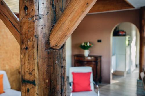 a wooden wall with a red chair in a room at Engelbarn in Engelbert