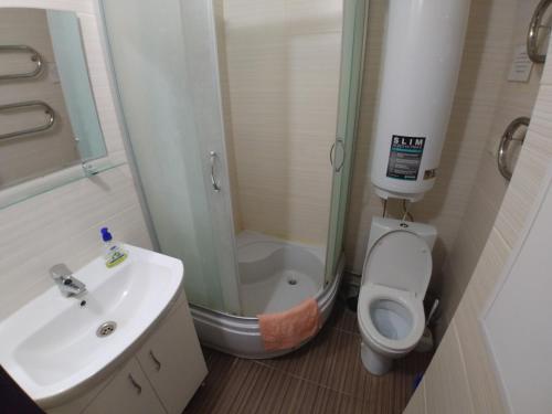 a bathroom with a shower and a toilet and a sink at Отель Юность in Kyiv