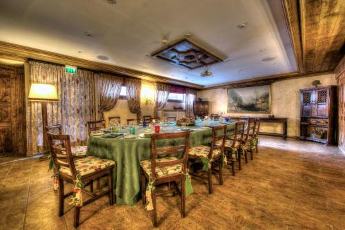 a dining room with a long table and chairs at Villa Novecento Romantic Hotel - Estella Hotel Collection & Experience in Courmayeur