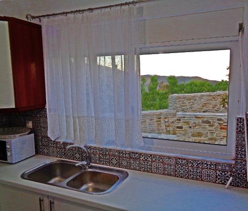 a kitchen with a sink and a window at Green view village in Pitrofós