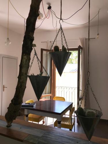 a dining room with a table and a tree at Casetta di Lele in Palermo