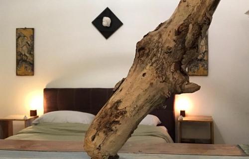 a tree branch sitting on top of a bed at Casetta di Lele in Palermo