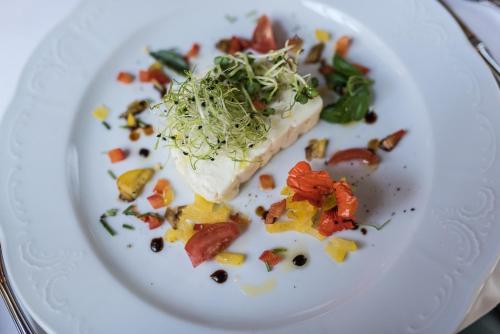 a white plate with a piece of food on it at Gasthof zum Hirschen in Burgau