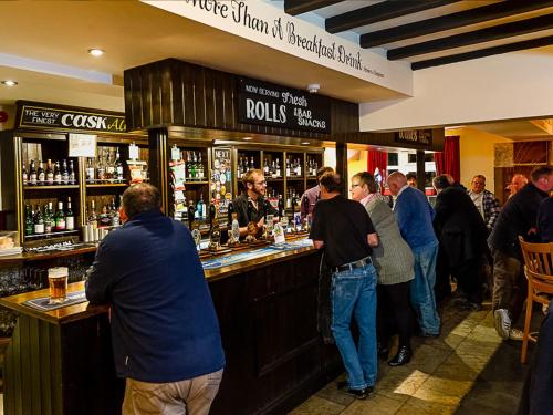 a group of people standing at a bar at The Horse and Jockey in Stapleford