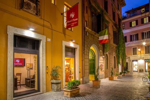 a street in a city with a yellow building at Hotel Forte in Rome