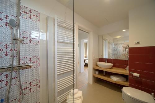 a bathroom with a toilet and a sink and a shower at Hotel Ristorante Da Tullio in Tarzo