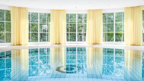 a room with a pool with windows at Hotel Marica in Eggen