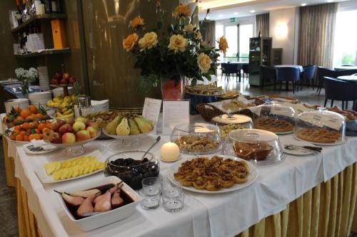 a table with many different types of food on it at Hotel Royal in Fermo