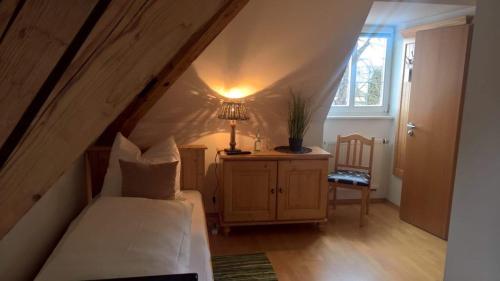 a bedroom with a bed and a lamp in a attic at Mettner Hof in Metten