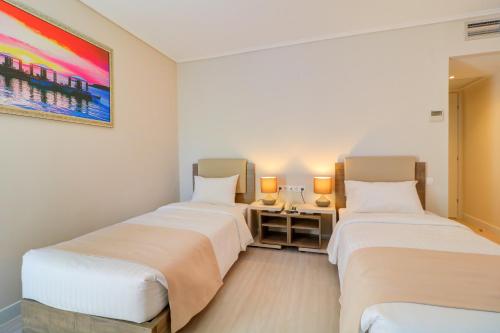 Un ou plusieurs lits dans un hébergement de l'établissement Palace Hotel Glyfada