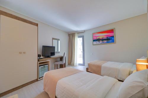 Un ou plusieurs lits dans un hébergement de l'établissement Palace Hotel Glyfada