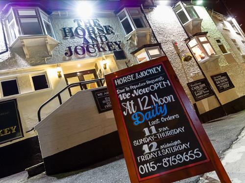 a sign in front of a building with a restaurant at The Horse and Jockey in Stapleford