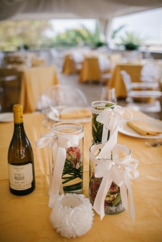 a table with a bottle of wine and two glasses at Hotel Royal in Fermo