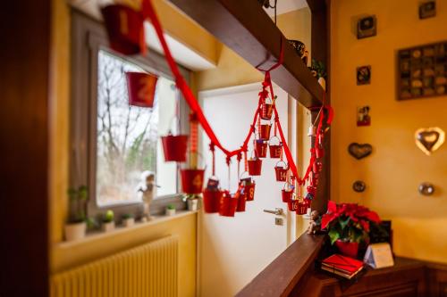 a hallway with red christmas decorations on the wall at La Rose Trémière in Wintzenheim-Kochersberg
