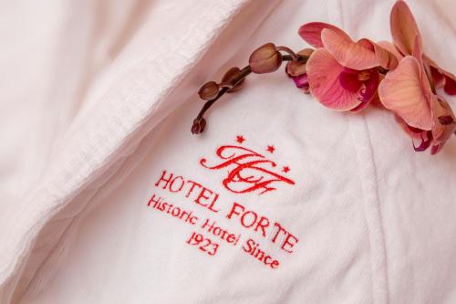 a hotel forrester sign on a towel with flowers at Hotel Forte in Rome