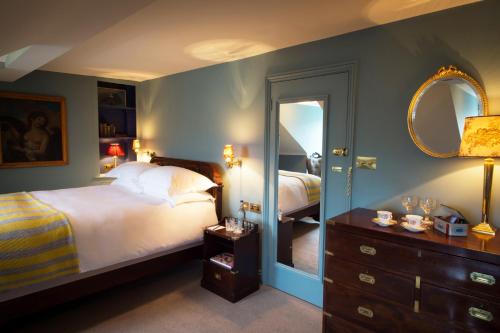 a bedroom with a bed and a mirror at The Portobello Hotel in London