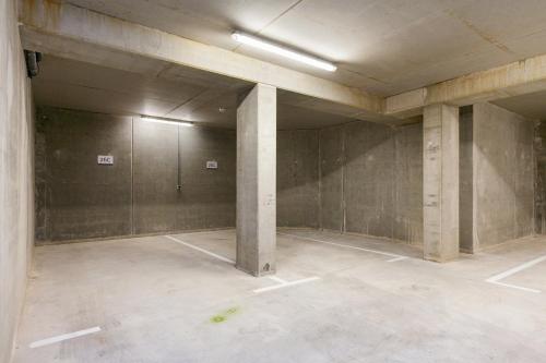 an empty room with concrete pillars in a building at Mezger Lodges in Domburg