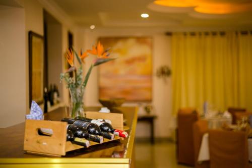 a table with a box of wine bottles on it at Hotel Rudi in Nairobi
