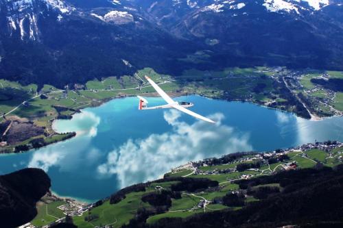 a plane flying over a lake in the mountains at Ferienhof Unterführholzergut in Klaus