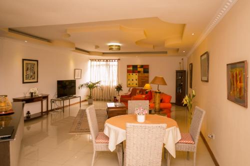 a living room with a table and chairs at Hotel Rudi in Nairobi