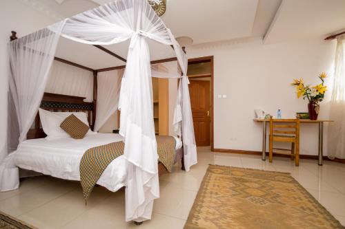 a bedroom with a bed with a canopy at Hotel Rudi in Nairobi